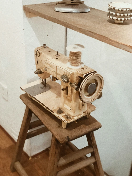 an antique sewing machine sitting on top of a table