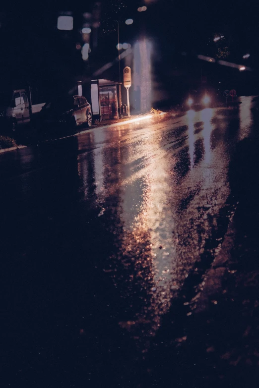 a street scene at night with a city street light