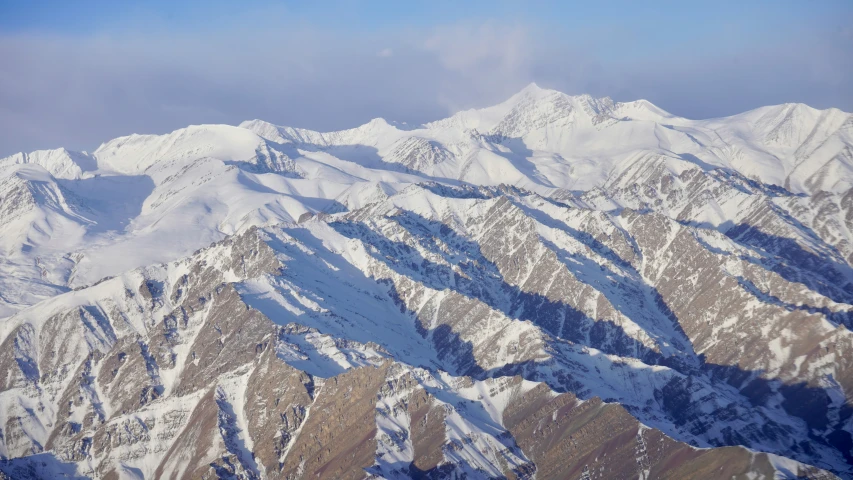 a mountain is shown from an airplane during winter