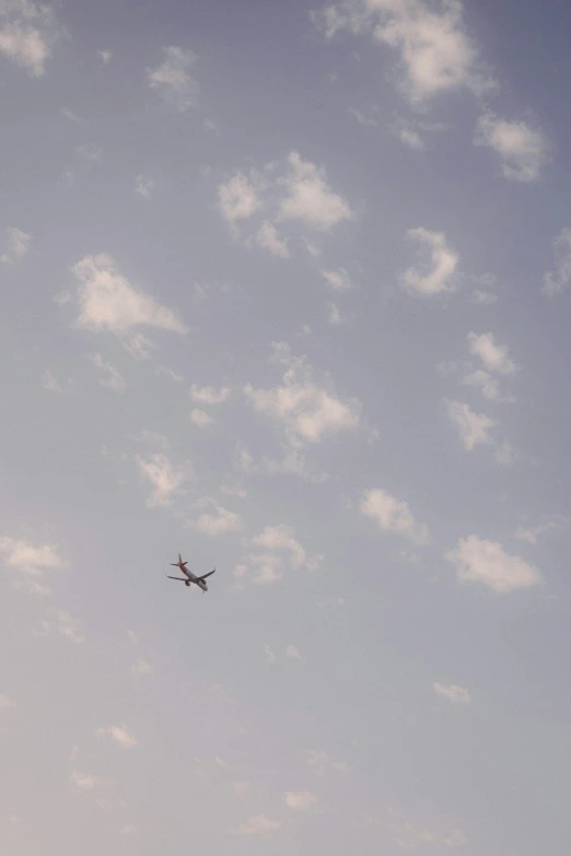 a airplane flying in the air over an airport