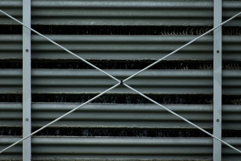 metal slats with rivets against a black backdrop