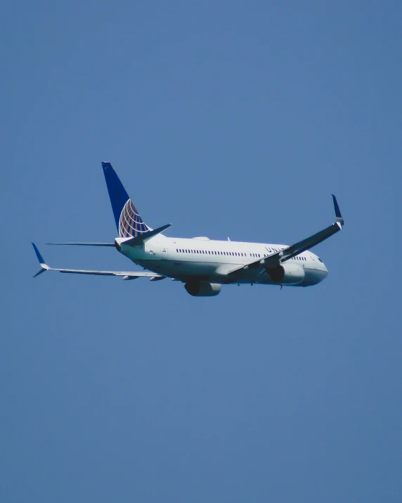 a united airplane is flying in the sky