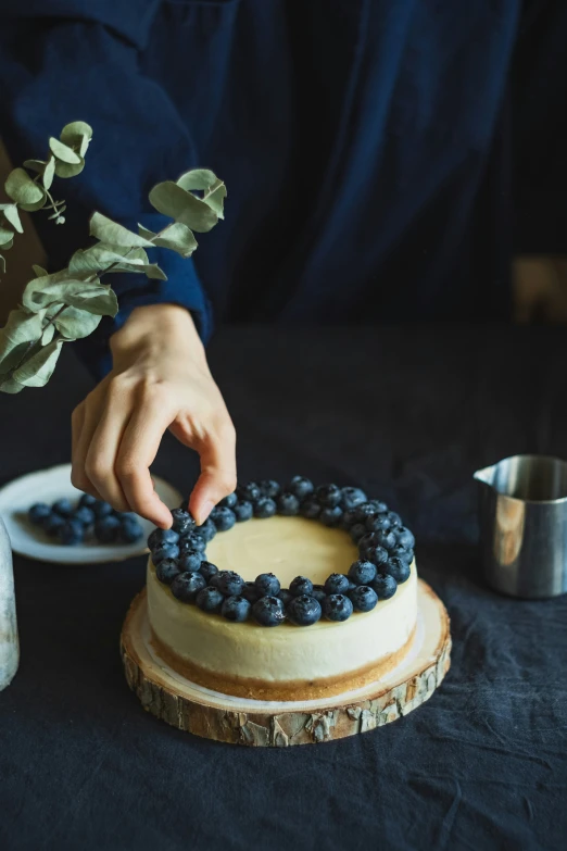 a person with a blue and yellow cake