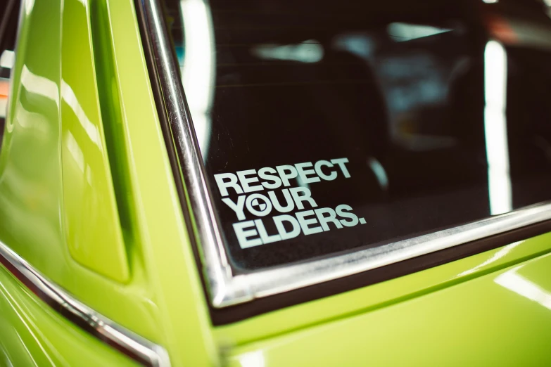 a sticker is in the window of a green vehicle