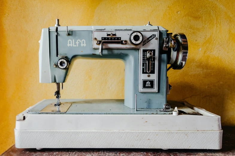 a close up of a blue sewing machine