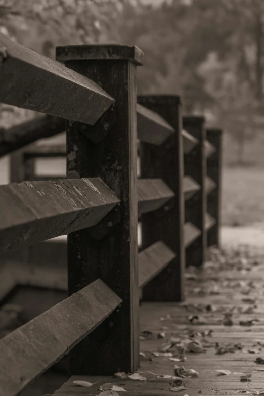 a bench by some railing on a rainy day