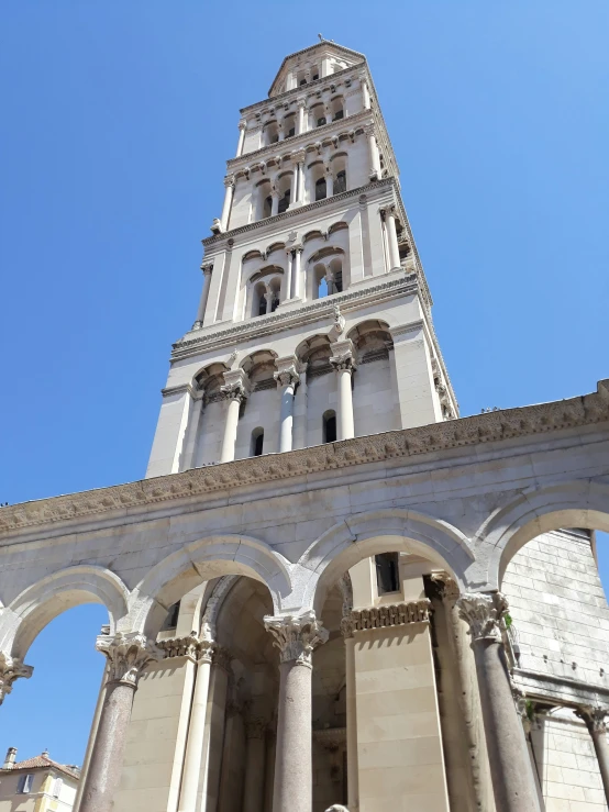 a tall white tower sitting above a church