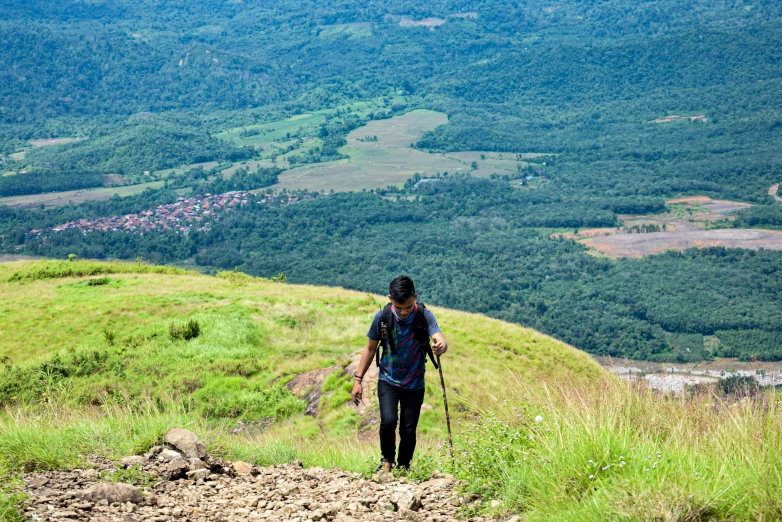 a person hiking along the side of a hill