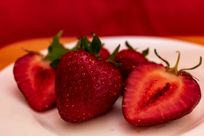 there is a plate full of strawberries on the table