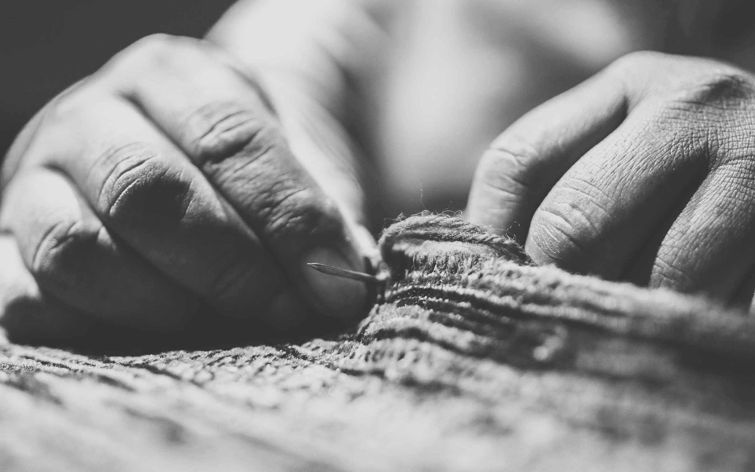 a person threading on a piece of clothing