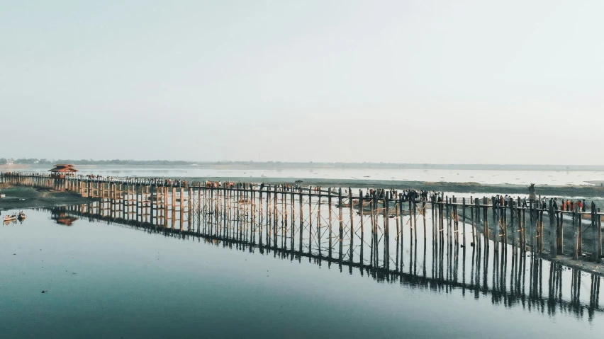 an aerial view of a pier on the ocean