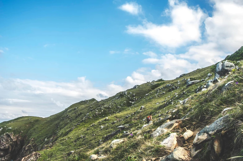 many people walking on the side of the mountains