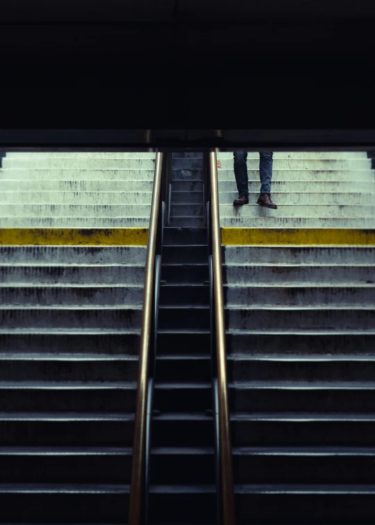 a person walking up some stairs carrying an umbrella