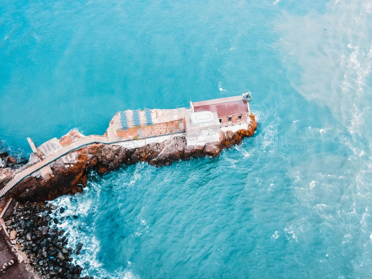 an aerial s of a dock on a blue ocean