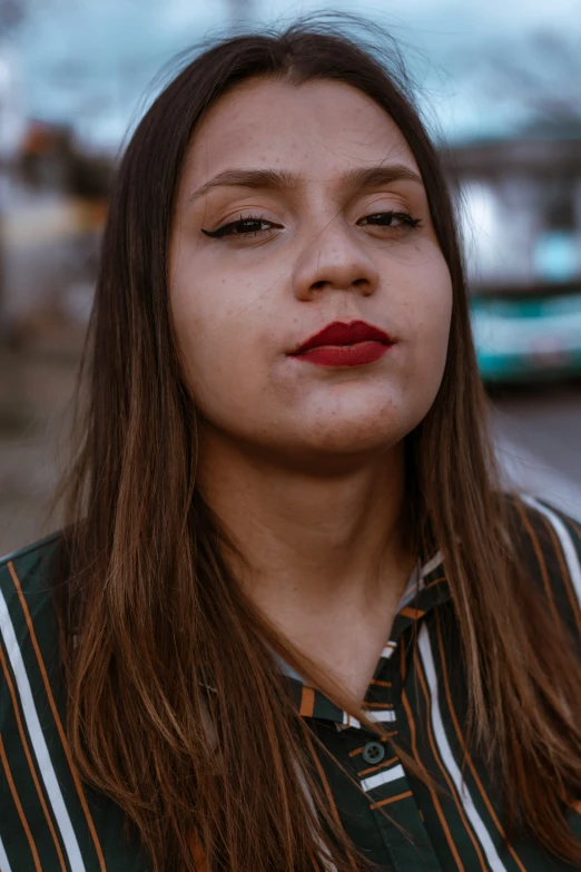 a woman with long brown hair is talking on a cell phone