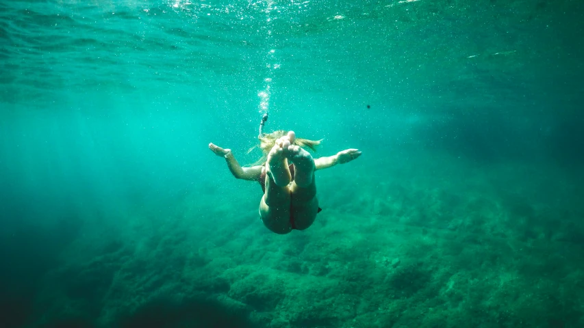 a man is diving underwater in the ocean
