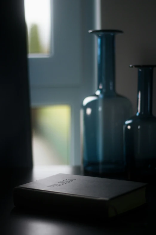 a table that has some vases and book on it