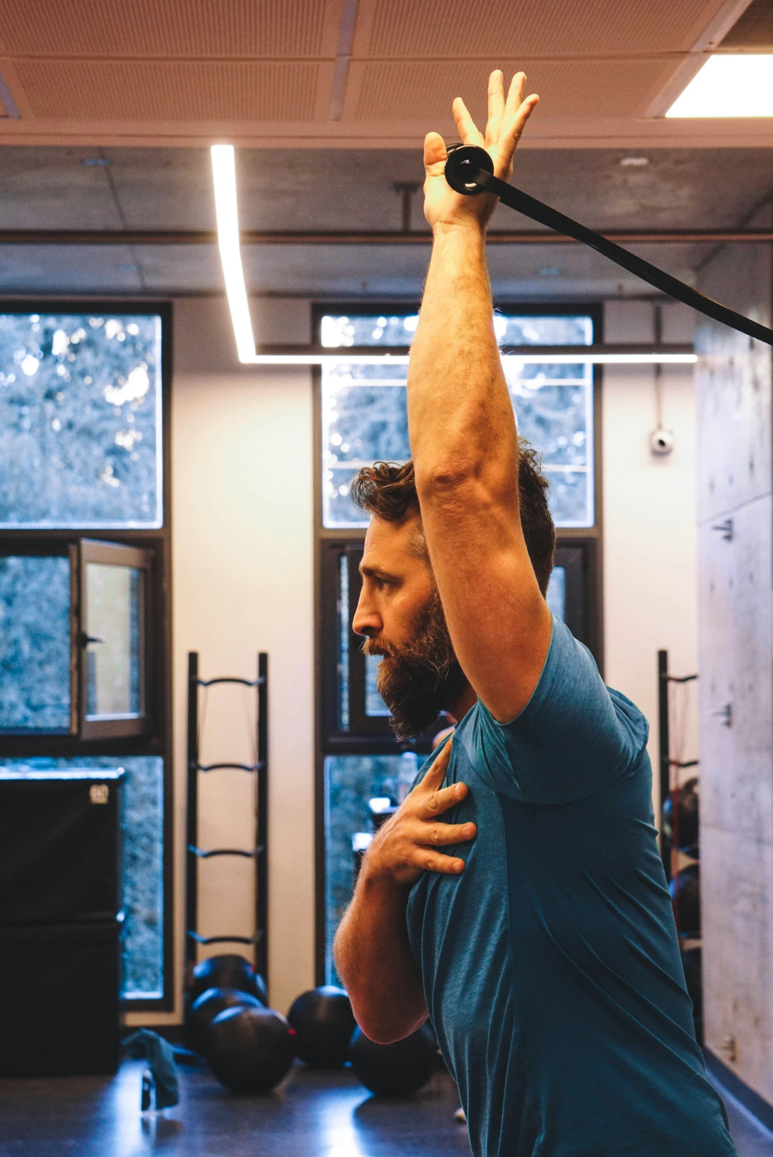 a man stretching with a pull rope in a gym