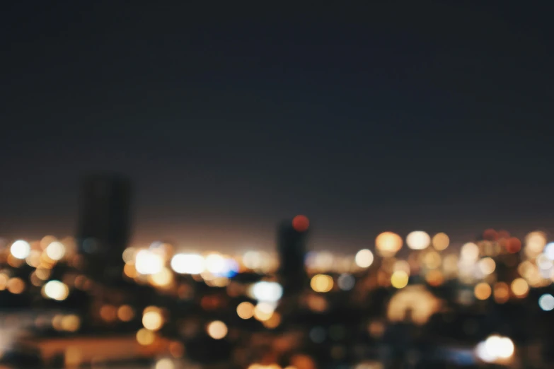 a city with buildings in the distance at night