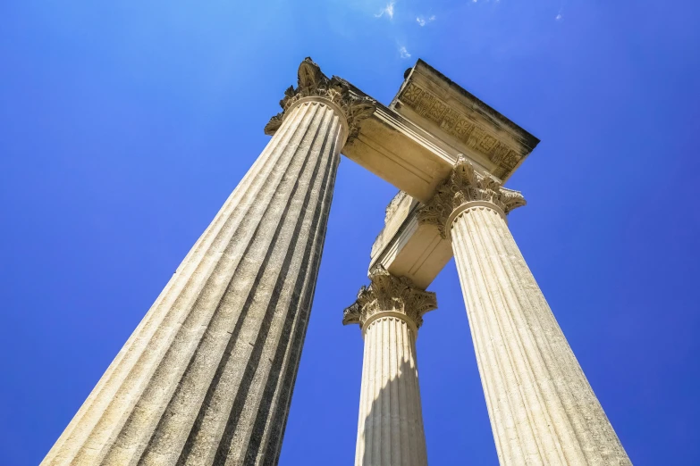 three columns against a bright blue sky, with no clouds