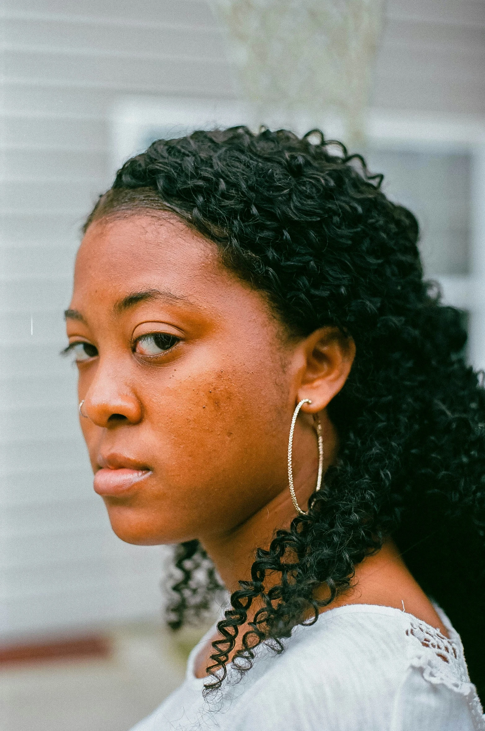 a woman wearing earrings on her head