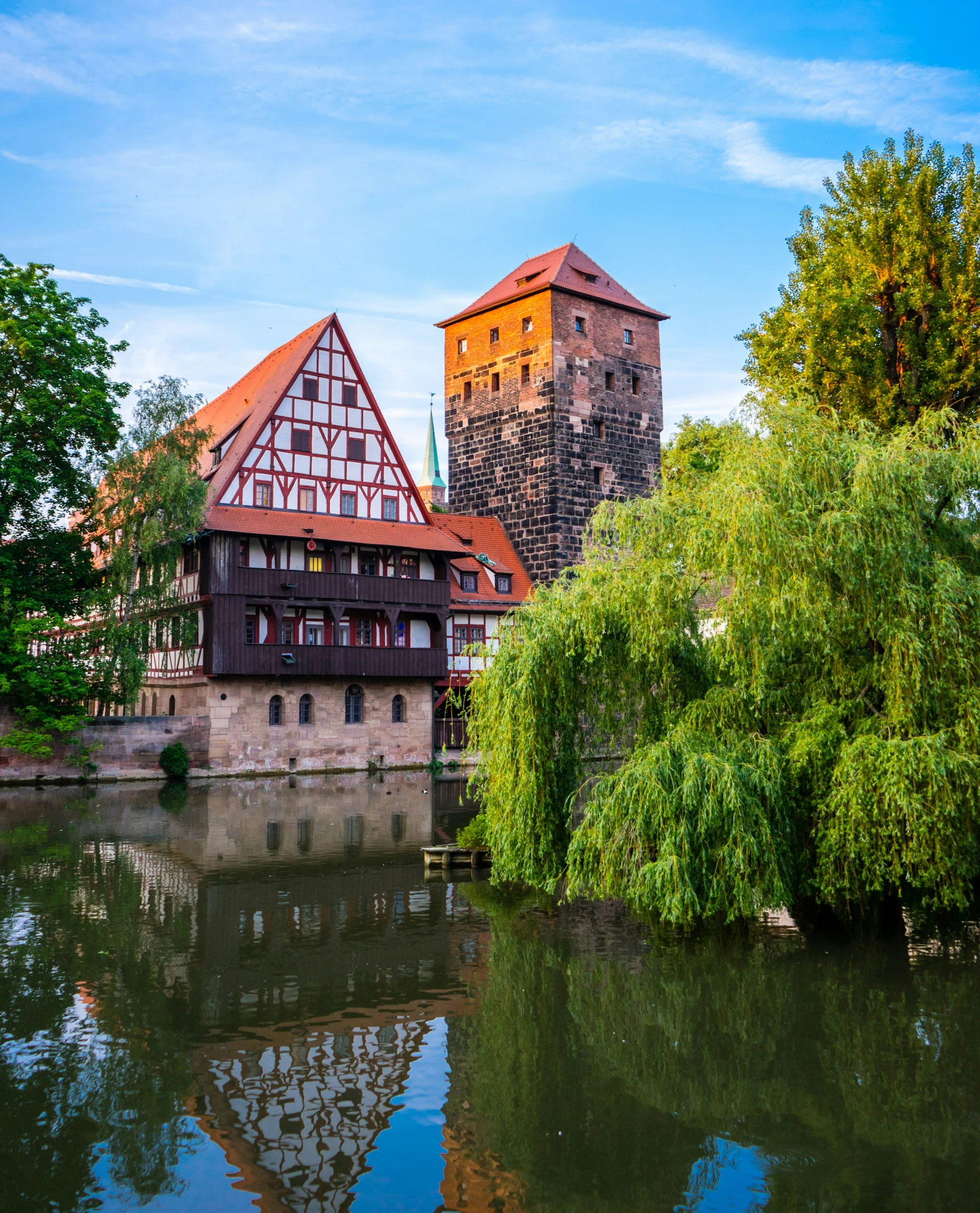 two different buildings near one another on a river