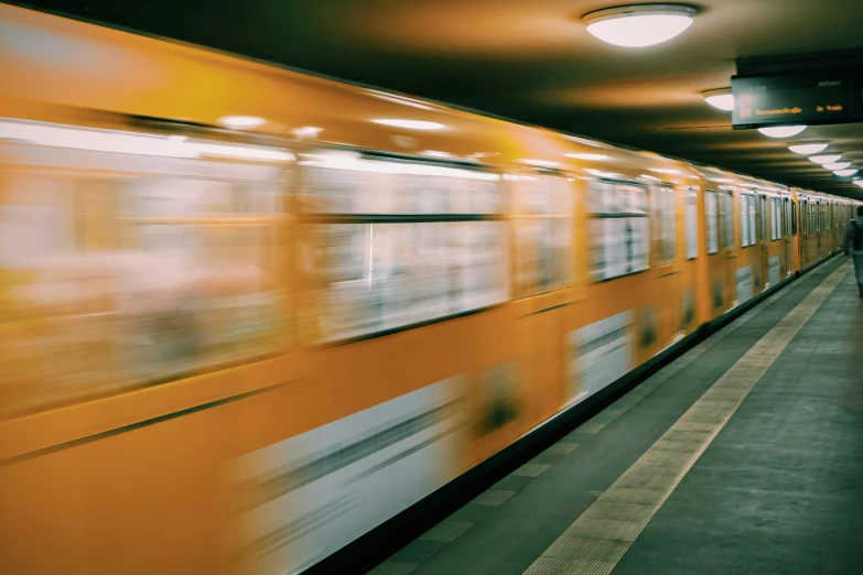 a man walking in front of a subway moving past it