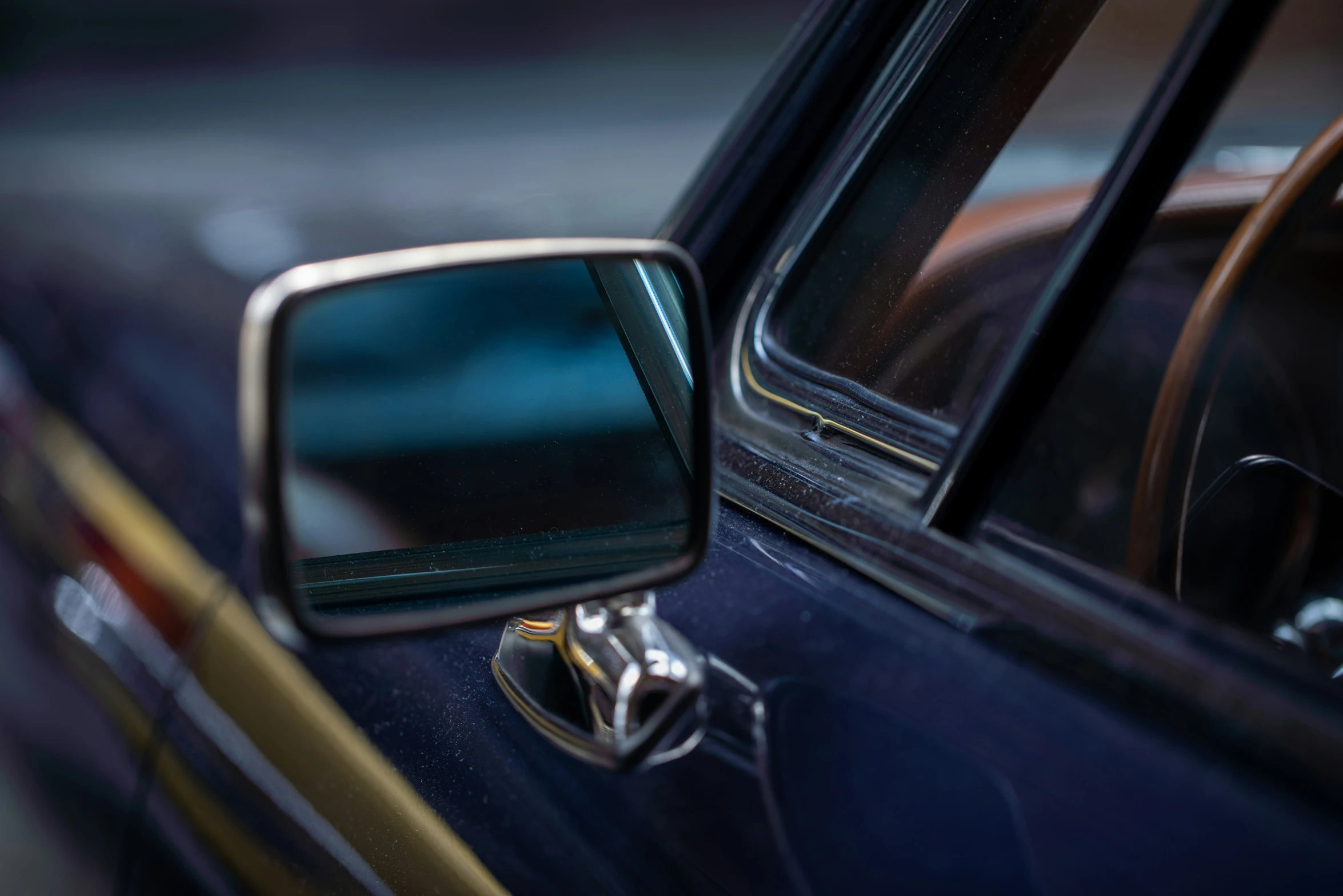 a rear view mirror of a car with soing on the door