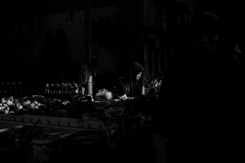 a group of people sitting around a dark room