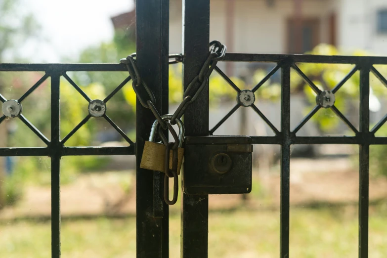 a close up s of the iron gate with padlocks