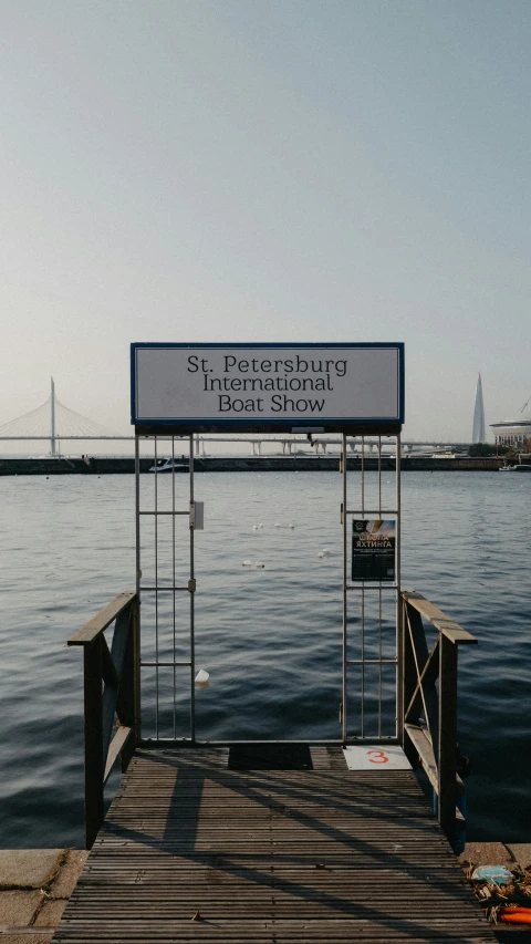 a pier next to a body of water with a sign