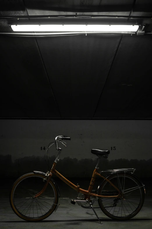 a bike parked in a parking garage with a neon light above