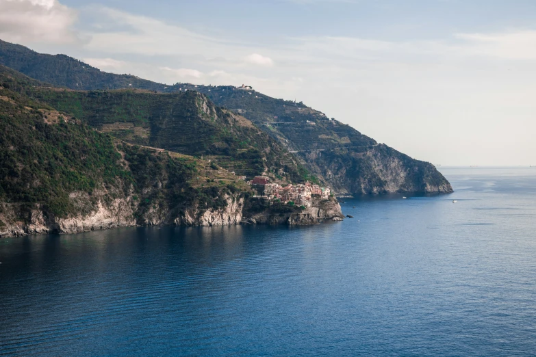 an ocean with the sea next to the cliff