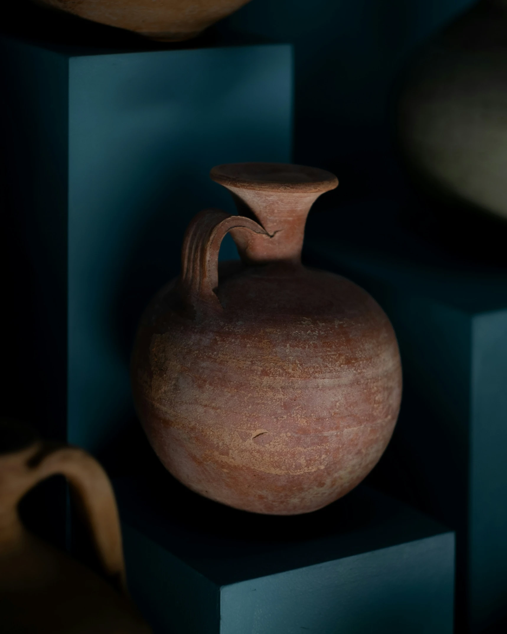 a vase on a shelf with others sitting near it