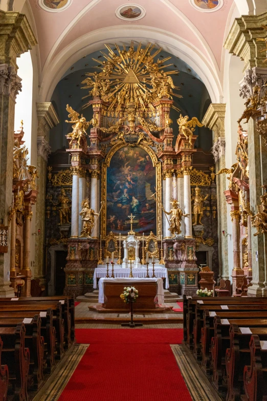 a cathedral with statues, alters, and a carpeted aisle