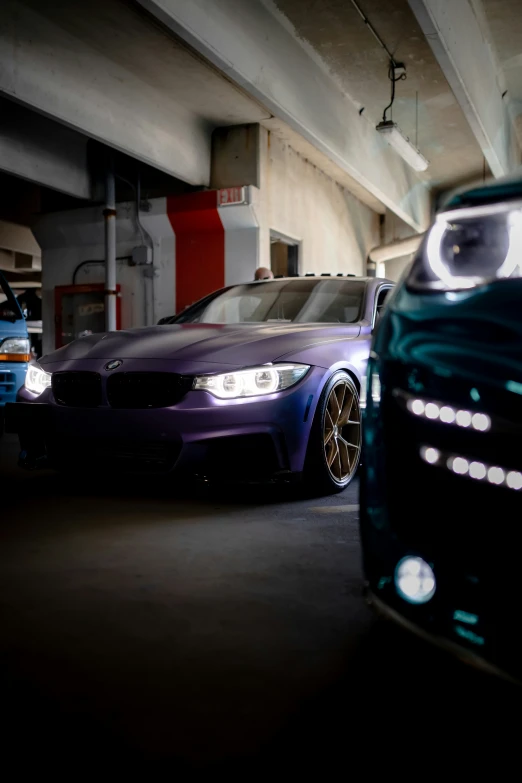 two cars parked next to each other in a building