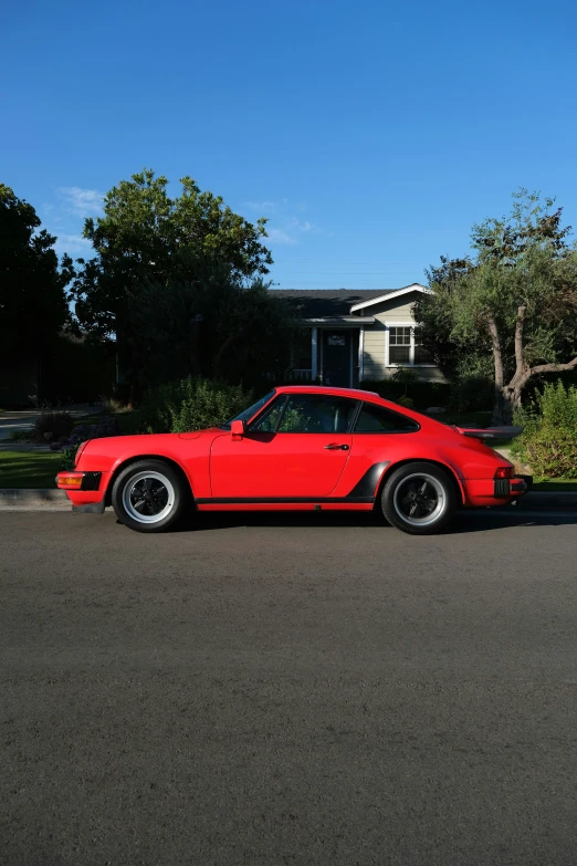 a bright red porsche parked on the street