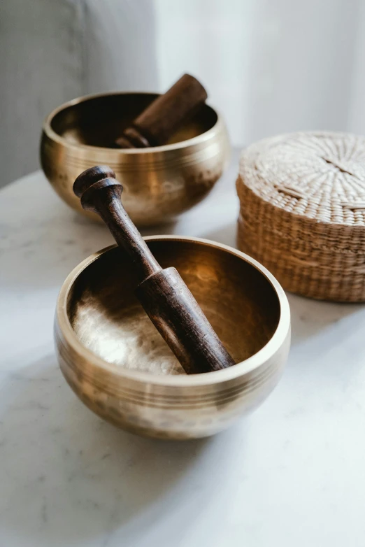 two wooden bowls sitting on top of a white counter