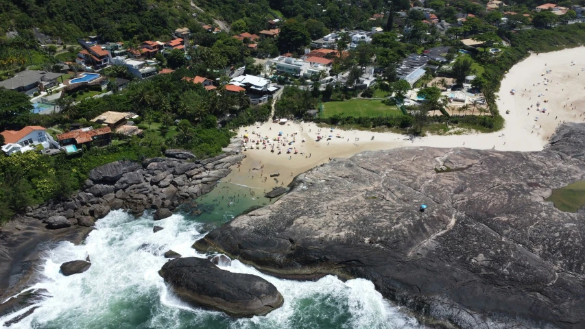 an aerial view shows a white sandy beach with waves