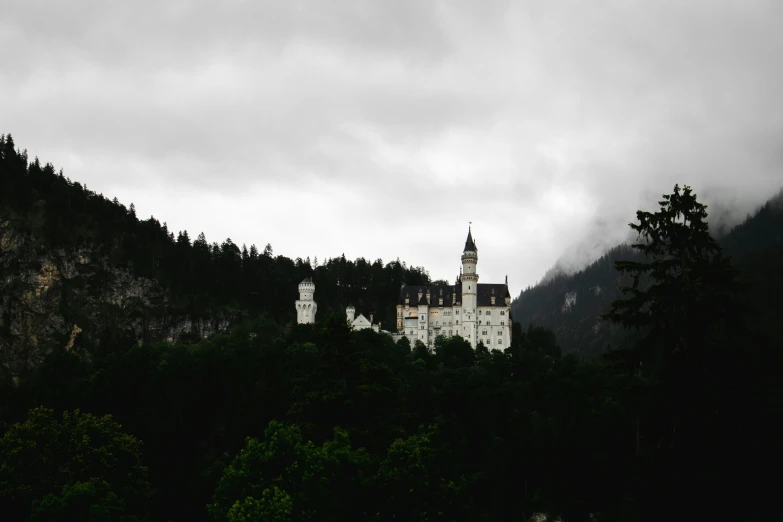 a castle surrounded by fog and low - lying clouds