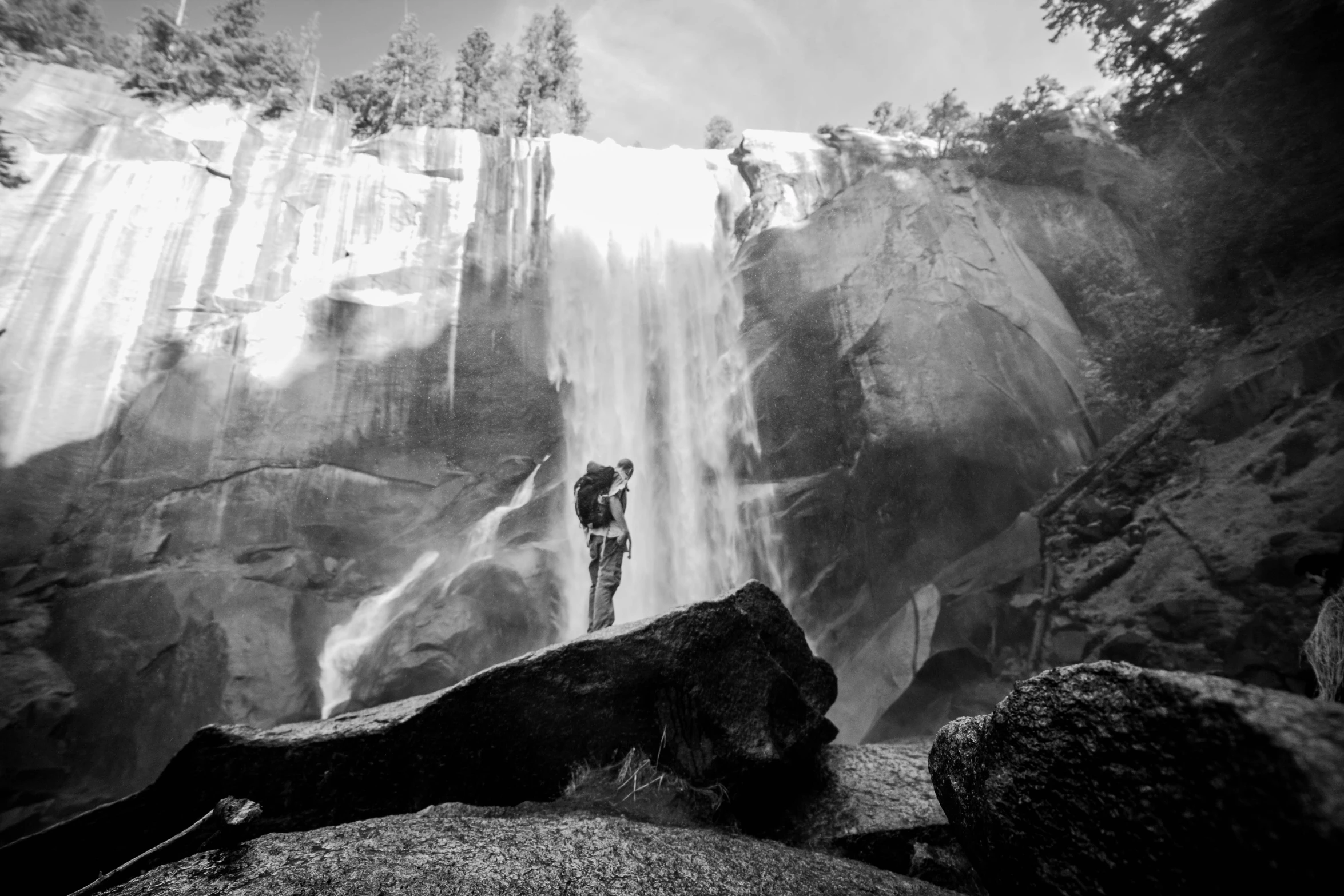 an image of a man standing under a waterfall