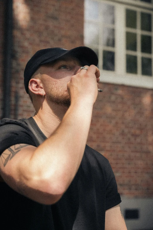 a man who is wearing a hat and standing outside