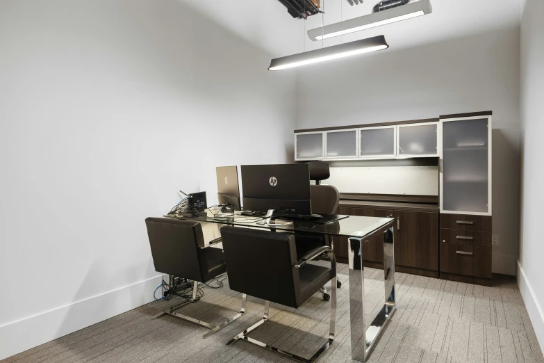 an office with a computer and chair in it