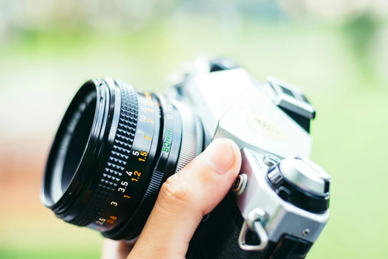 a person holding a small camera up to their face