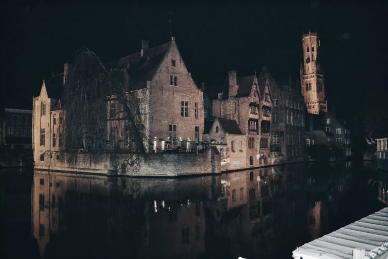 old city buildings sit at the edge of a river