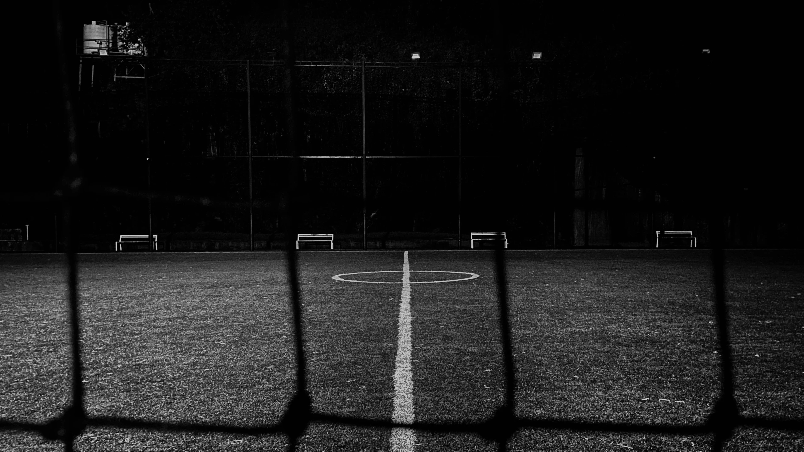the inside of a soccer goal at night