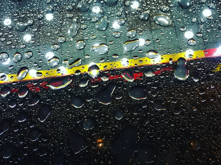 raindrops on an umbrella are shown in this closeup image