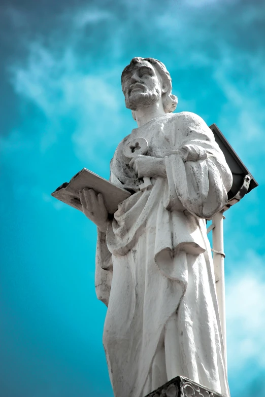 the statue of lady justice holds a book