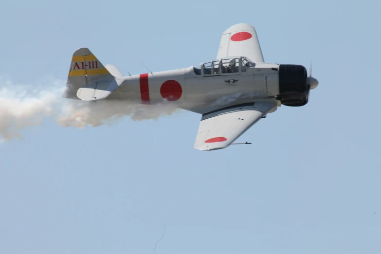 a red and white jet fighter performing on a clear day