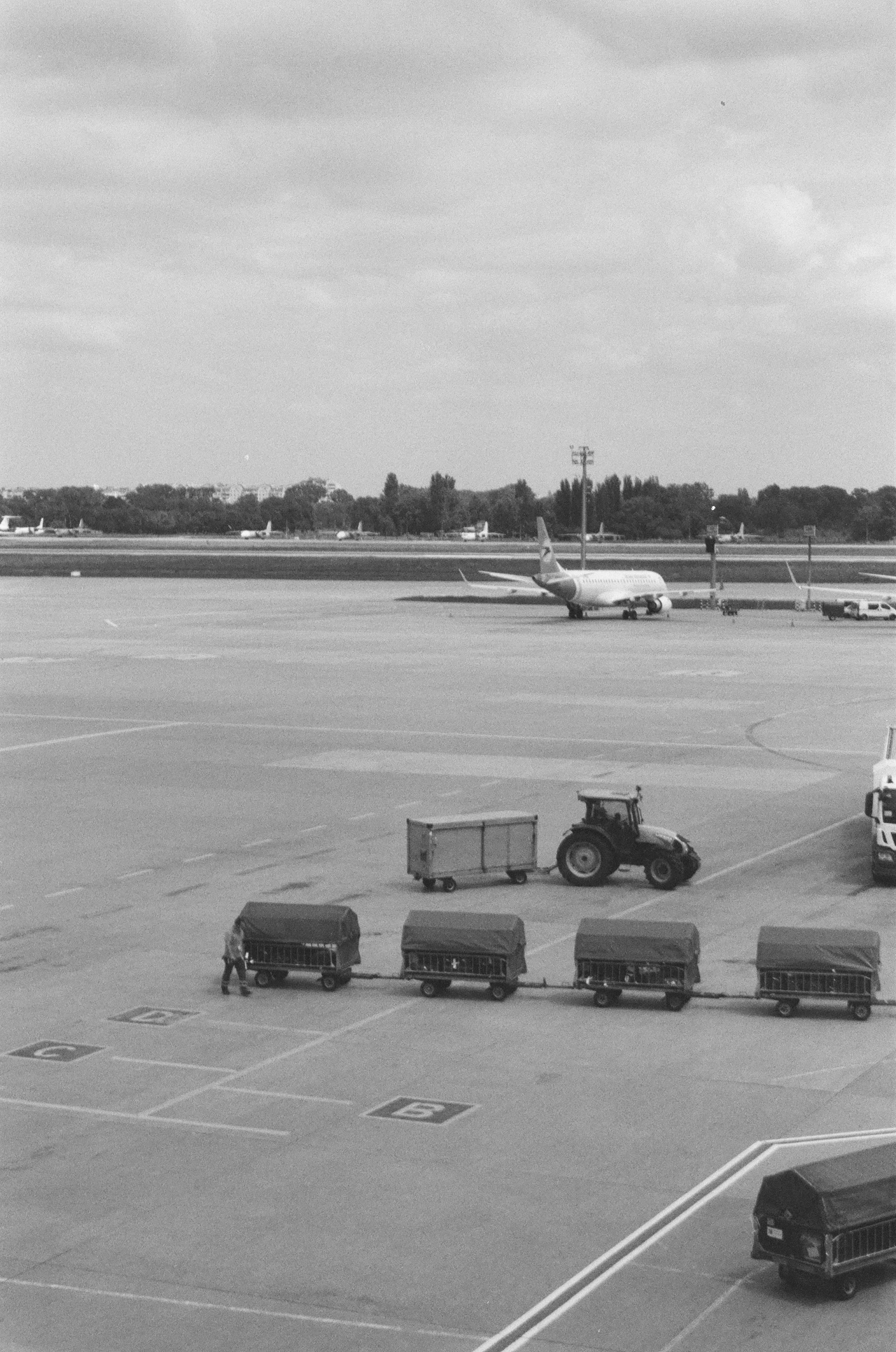 a black and white po of vehicles parked in an airport